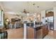 Open kitchen with granite countertops, stainless steel dishwasher, and breakfast bar open to living room at 327 64Th Avenue E Cir, Bradenton, FL 34203