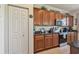 Bright kitchen with wood cabinets, granite counters, stainless steel appliances, and a pantry closet at 327 64Th Avenue E Cir, Bradenton, FL 34203