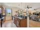 Open kitchen featuring granite countertops, stainless steel appliances, and a view into the living area at 327 64Th Avenue E Cir, Bradenton, FL 34203