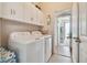 Laundry room with white cabinets and a washer and dryer set at 327 64Th Avenue E Cir, Bradenton, FL 34203