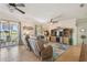 Cozy living room with tile floors, ceiling fan, and a view of the outdoor patio at 327 64Th Avenue E Cir, Bradenton, FL 34203