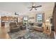 Open-concept living room with leather seating and a seamless flow to the kitchen at 327 64Th Avenue E Cir, Bradenton, FL 34203