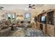 Comfortable living room with leather sofas, TV console, and natural light at 327 64Th Avenue E Cir, Bradenton, FL 34203
