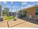 This screened-in patio is perfect for outdoor gatherings with a grill, comfortable seating, and stunning views of the backyard at 327 64Th Avenue E Cir, Bradenton, FL 34203