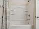 Shower with built-in shelving and decorative shower curtain at 327 64Th Avenue E Cir, Bradenton, FL 34203
