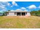 Spacious backyard featuring lush green grass and a view of the home's enclosed patio at 3510 Shawn St, Punta Gorda, FL 33980