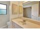Bathroom featuring a vanity with a stone countertop and cabinets with a large mirror above the sink at 3510 Shawn St, Punta Gorda, FL 33980