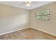 Bright, empty bedroom features wood-look flooring, a window, and a ceiling fan at 3510 Shawn St, Punta Gorda, FL 33980