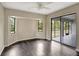 Bedroom with dark-stained wood floors, natural light, and access to the screened porch at 3510 Shawn St, Punta Gorda, FL 33980
