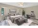 Modern bedroom features neutral tones, a ceiling fan, and a work space with a gray desk at 3510 Shawn St, Punta Gorda, FL 33980