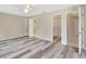 Bright bedroom with wood-look flooring, a ceiling fan, and access to other rooms at 3510 Shawn St, Punta Gorda, FL 33980