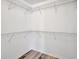 Walk-in closet features shelving and wood-look flooring, perfect for storage at 3510 Shawn St, Punta Gorda, FL 33980