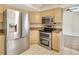 Kitchen featuring stainless steel appliances, light wood cabinets, and a tile floor at 3510 Shawn St, Punta Gorda, FL 33980