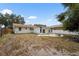 This backyard features a patio with a fire pit and a home with white siding at 3616 Stardust Pl, Sarasota, FL 34232