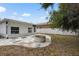This backyard features a patio with a fire pit and a home with white siding at 3616 Stardust Pl, Sarasota, FL 34232