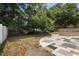 This backyard features a fire pit and patio with a grassy area and a fence at 3616 Stardust Pl, Sarasota, FL 34232
