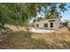 This backyard features a patio with a fire pit and a home with white siding at 3616 Stardust Pl, Sarasota, FL 34232