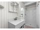 This bathroom features a modern vanity, a shower, and white walls with wood trim at 3616 Stardust Pl, Sarasota, FL 34232