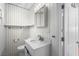 The bathroom features a modern vanity, a toilet, and white walls with wood trim at 3616 Stardust Pl, Sarasota, FL 34232