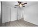 This bedroom features wood-look floors and a double-door closet with white walls at 3616 Stardust Pl, Sarasota, FL 34232