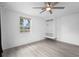 Bright and airy bedroom with light floors and an open closet storage area at 3616 Stardust Pl, Sarasota, FL 34232