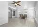 The dining room area features tile floors, a glass table, ceiling fans, and an attached entryway at 3616 Stardust Pl, Sarasota, FL 34232
