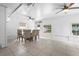 Bright dining room with tile floors, large windows, and modern ceiling fans offers a great space for gatherings at 3616 Stardust Pl, Sarasota, FL 34232