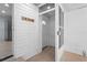 Mud room entryway with white-painted walls, coat rack, and tile flooring near kitchen at 3616 Stardust Pl, Sarasota, FL 34232