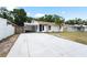 Inviting one-story home featuring a carport and freshly painted exterior with decorative fencing at 3616 Stardust Pl, Sarasota, FL 34232