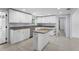 Updated kitchen features an island, stainless appliances, granite countertops, and modern white cabinets at 3616 Stardust Pl, Sarasota, FL 34232