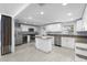 Updated kitchen features an island, stainless appliances, granite countertops, and modern white cabinets at 3616 Stardust Pl, Sarasota, FL 34232