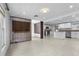 Open concept living space with wood divider, light tile flooring and views of the kitchen at 3616 Stardust Pl, Sarasota, FL 34232