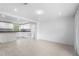 Open living space showcasing light floors and partial view of kitchen with island and granite countertops at 3616 Stardust Pl, Sarasota, FL 34232