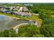 Aerial shot showcasing backyard screened-in pools, lush lawns and waterfront views at 370 Londonderry Dr, Sarasota, FL 34240