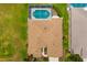 Aerial view of roof, screened-in pool, landscaped yard, and driveway at 370 Londonderry Dr, Sarasota, FL 34240