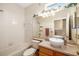 Bathroom with white tiled walls, a shower over tub combination, and a vessel sink with a decorative mirror at 370 Londonderry Dr, Sarasota, FL 34240
