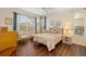 Bright bedroom featuring hardwood floors, a ceiling fan, and two windows with natural light at 370 Londonderry Dr, Sarasota, FL 34240
