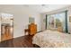 Bedroom featuring hardwood floors with a ceiling fan and view of the kitchen and living room at 370 Londonderry Dr, Sarasota, FL 34240