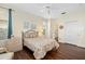 Bedroom showcasing hardwood floors, a ceiling fan, and an en-suite bathroom at 370 Londonderry Dr, Sarasota, FL 34240
