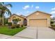 Well-maintained single-story home with a two-car garage, mature landscaping, and a neatly manicured lawn at 370 Londonderry Dr, Sarasota, FL 34240