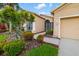 Charming home exterior highlighting lush landscaping, a screen door entrance, and a well-maintained walkway at 370 Londonderry Dr, Sarasota, FL 34240