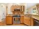 Close-up of kitchen showcasing stainless steel oven, sink, granite countertops, and wooden cabinetry at 370 Londonderry Dr, Sarasota, FL 34240