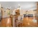 Spacious kitchen with granite countertops, wooden cabinets, and hardwood floors open to the living room at 370 Londonderry Dr, Sarasota, FL 34240
