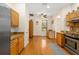 Bright kitchen with wooden cabinets, a window, stainless steel appliances, and hardwood floors at 370 Londonderry Dr, Sarasota, FL 34240