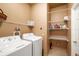 Functional laundry room featuring a washer, dryer, shelving, and ample storage space at 370 Londonderry Dr, Sarasota, FL 34240