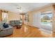 Living room with hardwood floors, neutral walls, view of the pool, and comfortable gray seating at 370 Londonderry Dr, Sarasota, FL 34240
