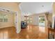 Open living room with hardwood floors, neutral walls, view of the pool, and comfortable blue seating at 370 Londonderry Dr, Sarasota, FL 34240