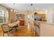 Open concept living space with dining area, breakfast bar, hardwood floors, and natural light at 370 Londonderry Dr, Sarasota, FL 34240
