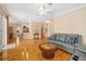 Open concept living space with hardwood floors, comfortable gray seating, and view to the entrance at 370 Londonderry Dr, Sarasota, FL 34240
