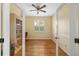 Bright office with hardwood floors, neutral walls, large window, and a built-in bookcase for storage and display at 370 Londonderry Dr, Sarasota, FL 34240